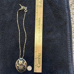 Gold toned sand dollar necklace